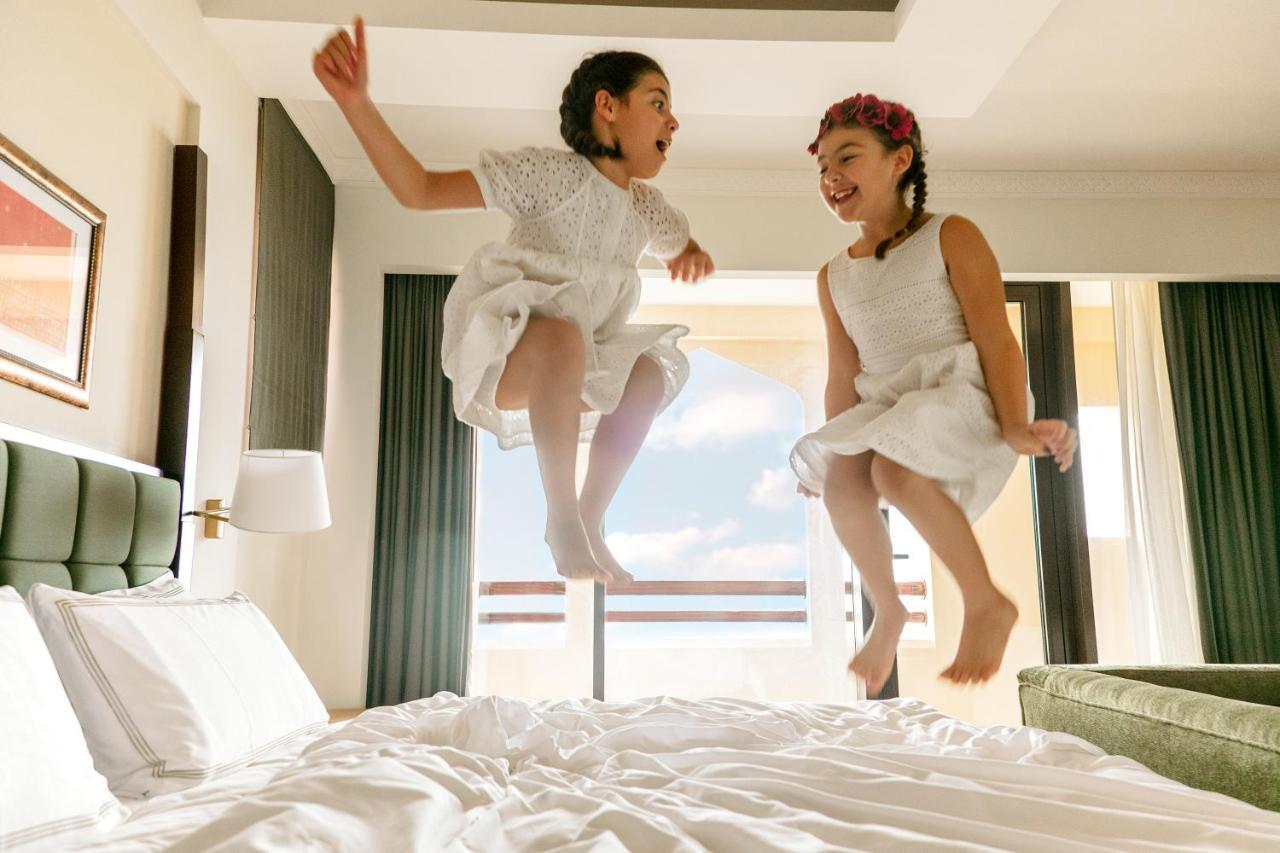 Shangri-La Barr Al Jissah, Mascate Exterior foto Two girls jumping on a bed